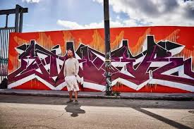 Siner holding a dripping spray can mid-piece